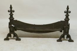 A large wrought iron inglenook fire grate / basket and fire dogs, 22 x 35cms, 57cm high