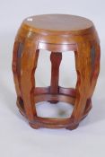 A Chinese hardwood barrel shaped stand with silver wire inlaid top, raised on shaped supports, 37