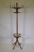 A vintage bentwood hall stand with swivel top and splay supports, 196cm high