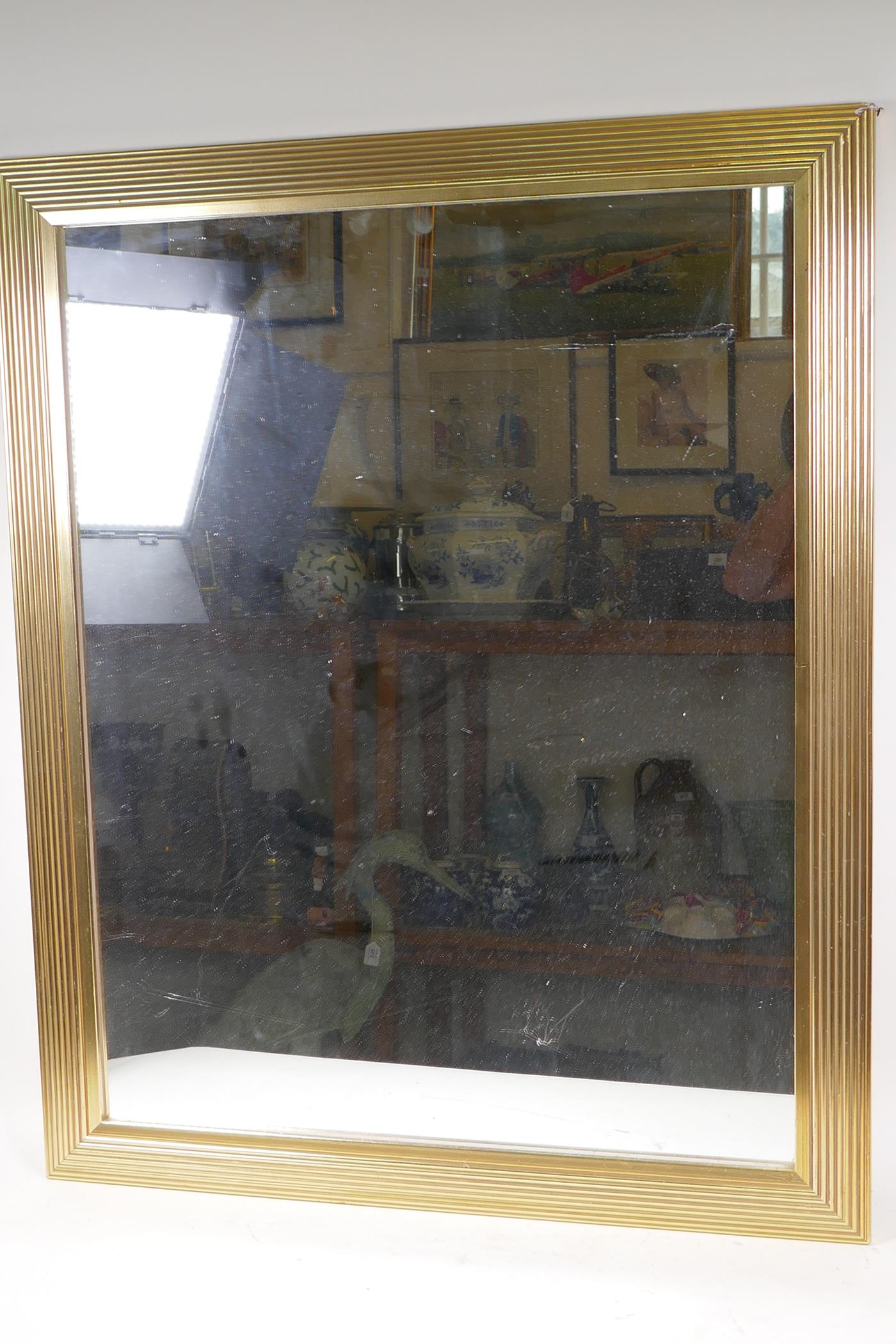 A reeded gilt framed wall mirror, 81 x 65cm overall