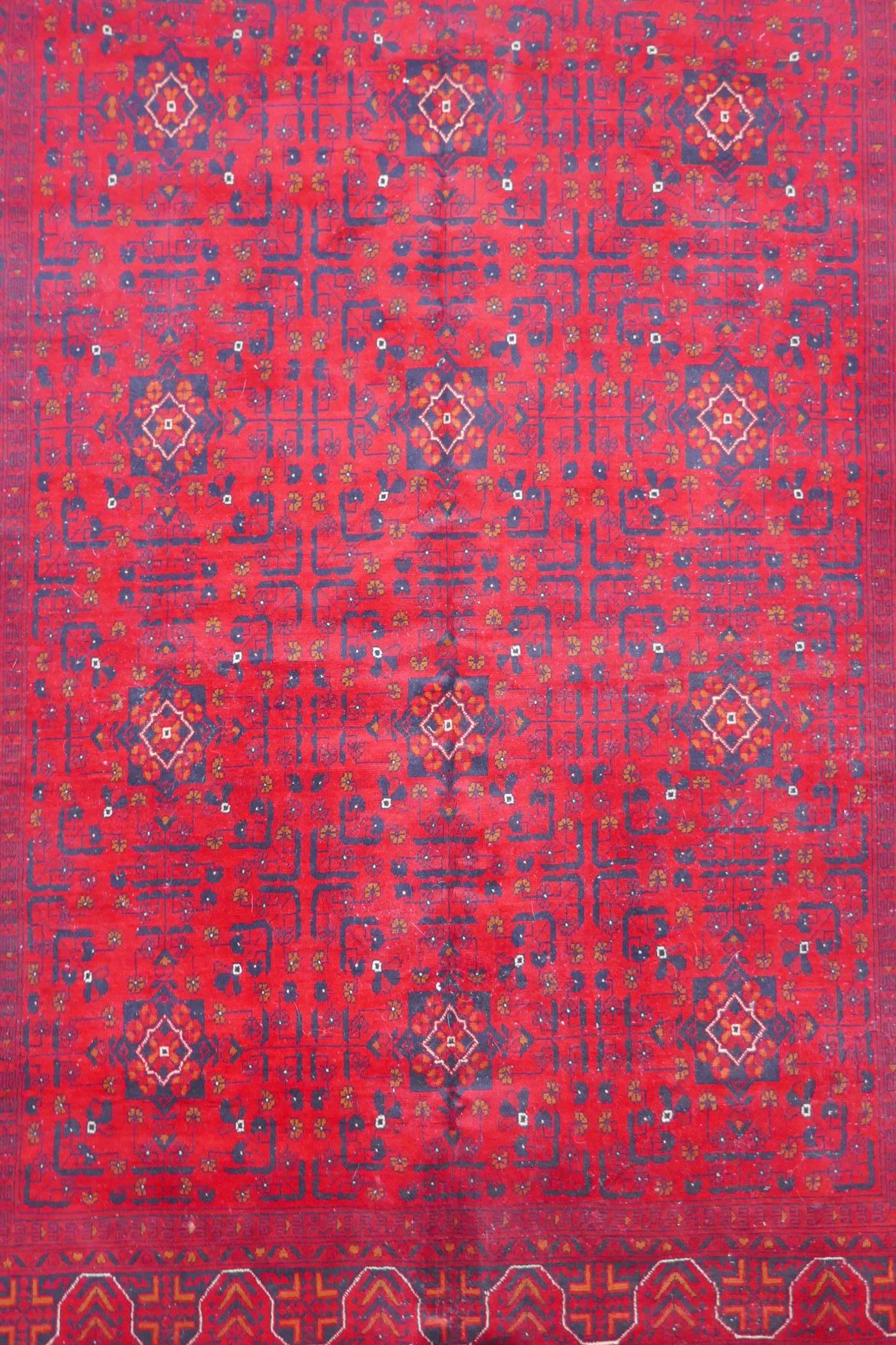 A Turkish deep red ground wool carpet with unique repeating floral geometric design, 165 x 230cms - Image 2 of 5