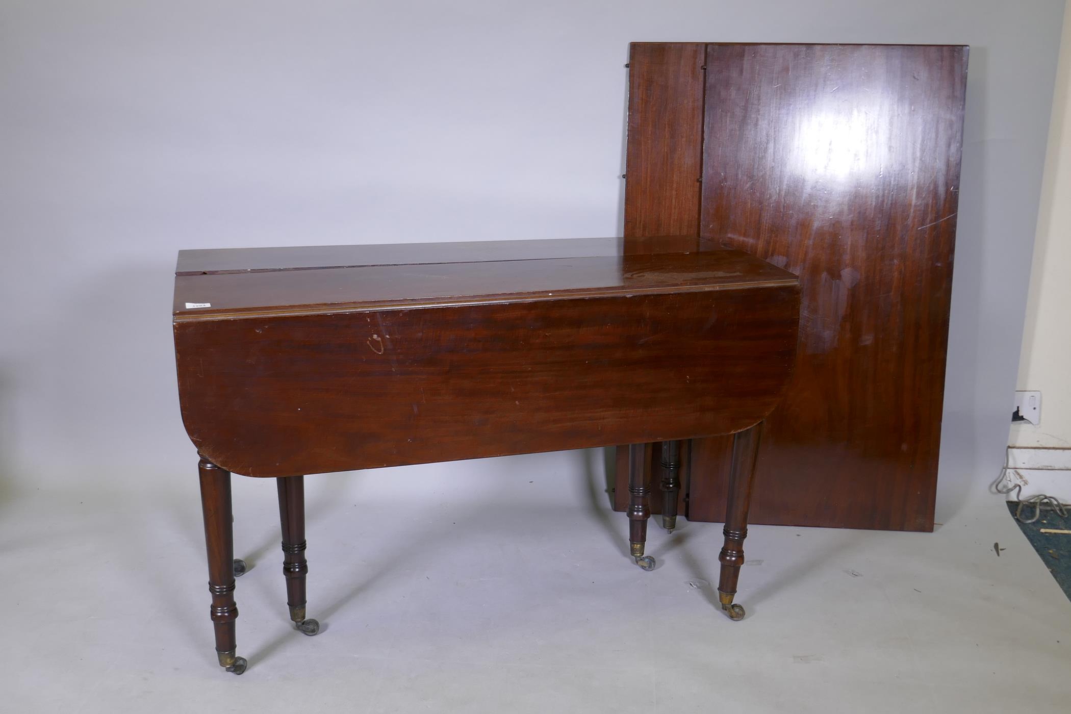 A C19th mahogany drop leaf dining table with concertina action and two extra leaves, one leg AF, 112