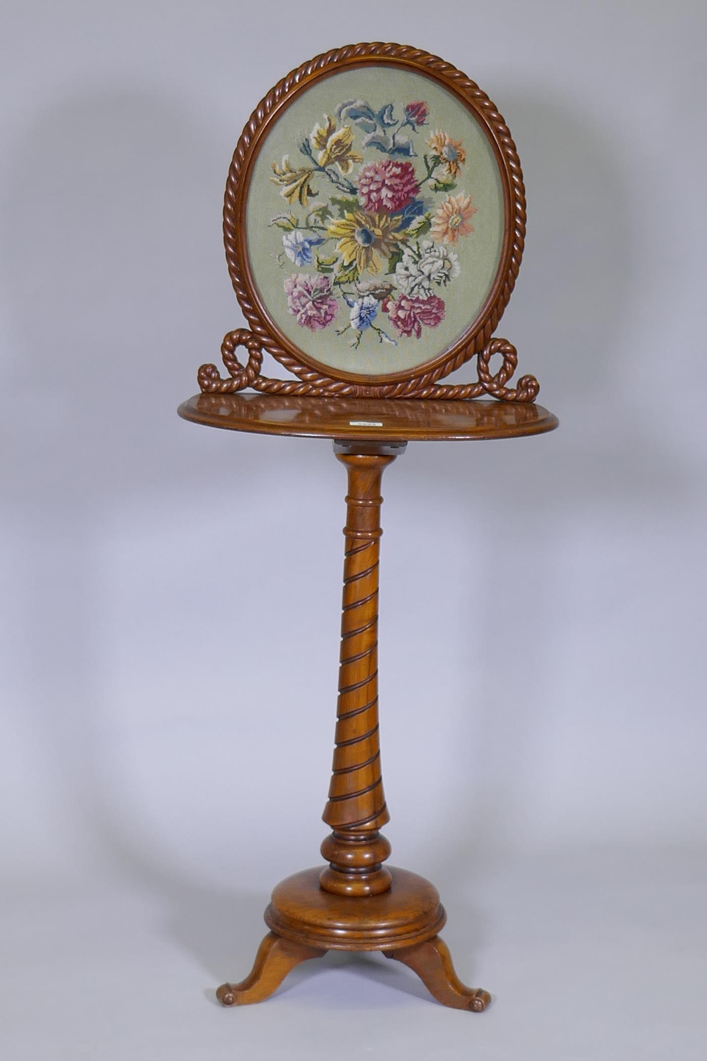 A C19th figured walnut polescreen / dressing table, with inlaid and carved decoration, and