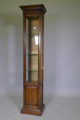 An illuminated display cabinet with glass shelves, bears label 'Brandt', 38 x 31 x 170cms