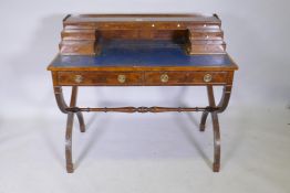 A C19th mahogany and yew wood writing desk with gallery top over eight stepped drawers, a leather