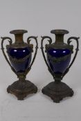 A pair of ormolu mounted porcelain side urns with a deep blue glaze, 23cm high