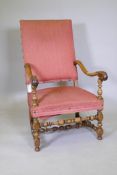 A C19th walnut high back throne chair with carved and scrolled arms, raised on turned supports