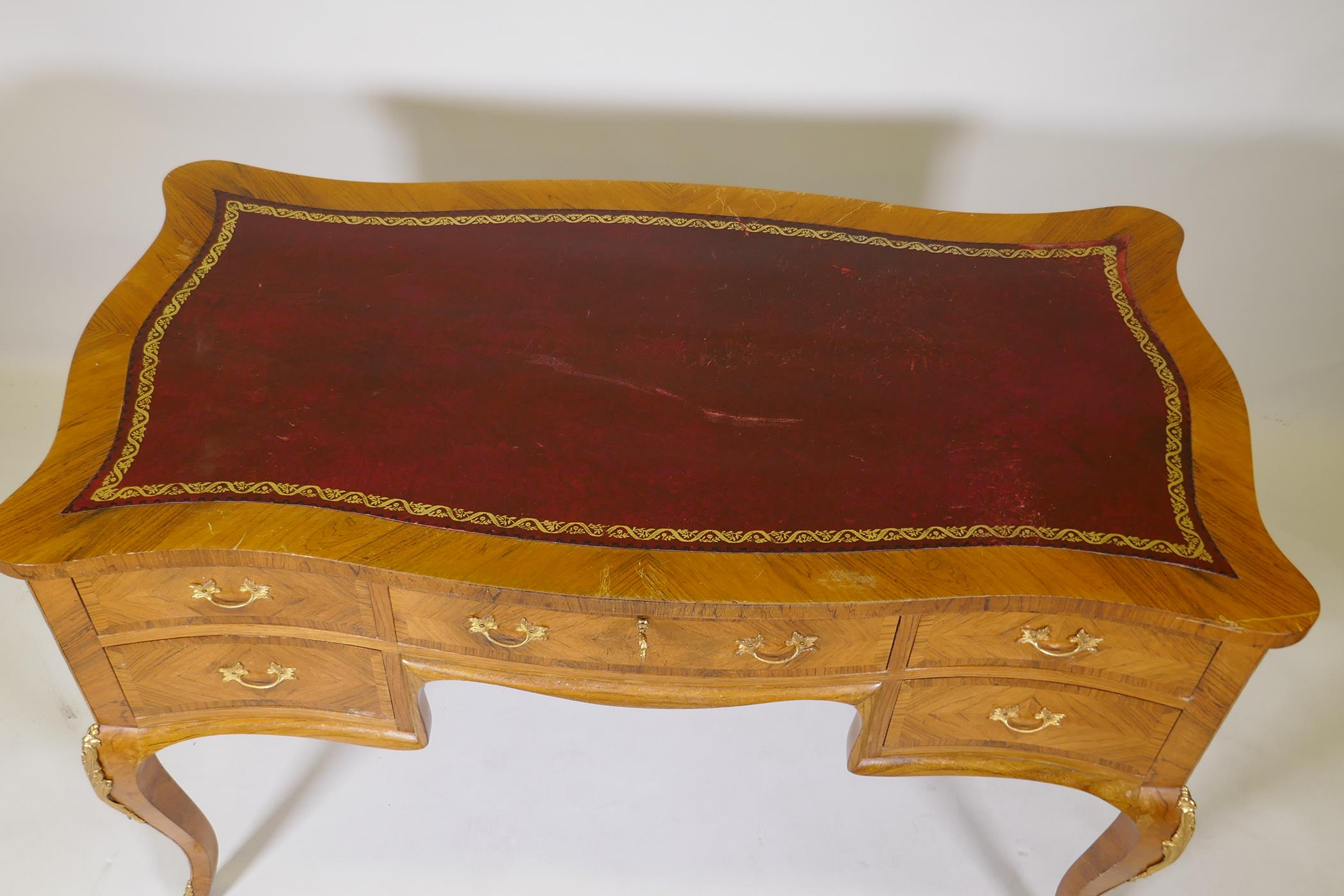 A French tulip wood and rosewood inlaid serpentine shaped five drawer kneehole desk, with gilt - Image 3 of 5