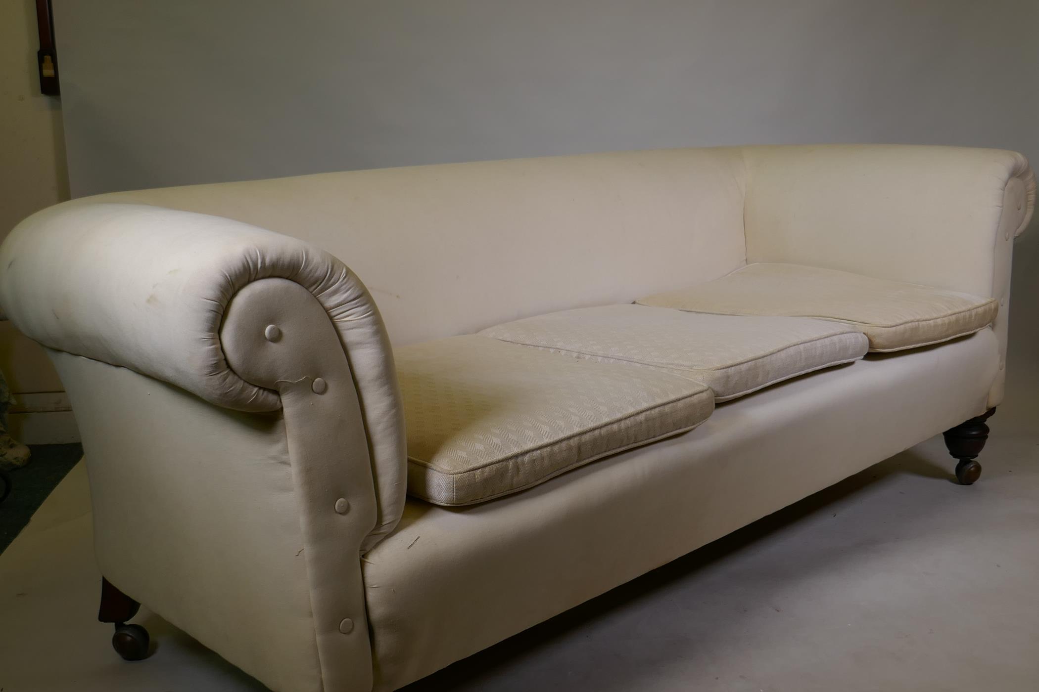 A Victorian Chesterfield settee with calico covers, raised on turned supports - Image 2 of 3