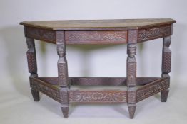 C19th oak credence table with lift up top, raised on four supports carved with terms, united by