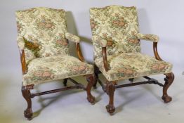 A matched pair of good late C18th/early C19th walnut Gainsborough chairs, with hump backs, raised on