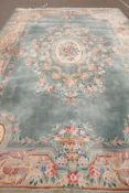 A good Chinese deep pile wool carpet with traditional design on a green field, 550 x 370cms