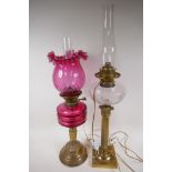 Two C19th brass column oil lamps converted to electricity, one with cranberry glass font and