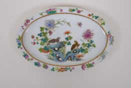 A Chinese Republic polychrome porcelain oval dish with enamel decoration of birds and flowers,