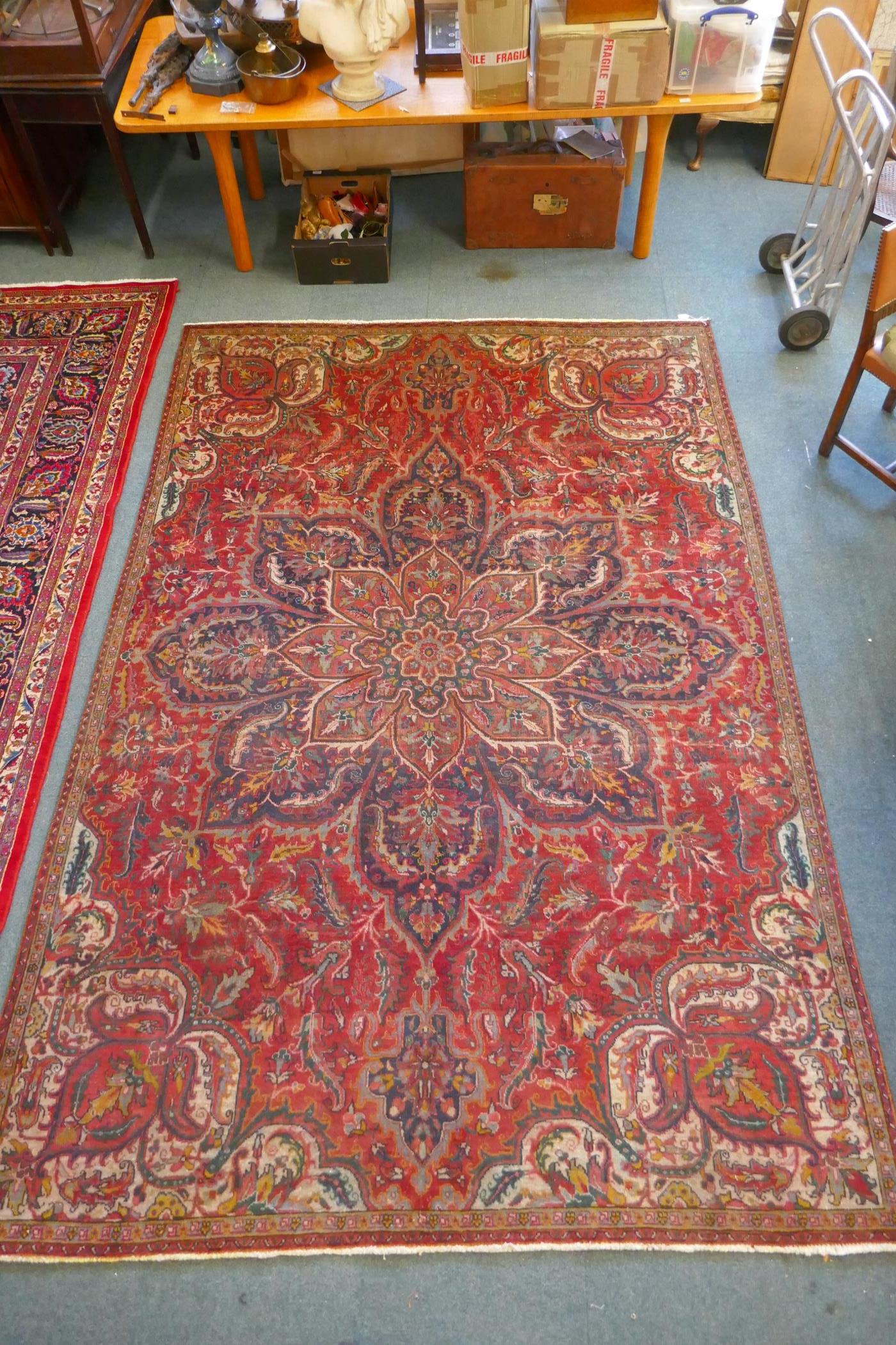 A Persian heavy pile red ground vintage Heriz carpet, Northern Iran tradition floral pattern,
