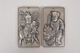 A pair of Chinese white metal scroll weights with raised figural decoration, 5 x 9cm