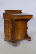 A Victorian inlaid walnut bow fronted davenport with blind tooled leather inset top and covered