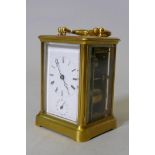 A brass repeater carriage clock, striking on a bell, 12cm high