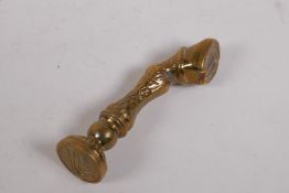 An antique brass seal with a horse's hoof knop, 7cm long