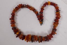 A graduated natural amber bead necklace, 45cm long