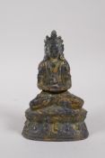 A Tibetan bronze figure of Buddha seated on a lotus throne, with the remnants of gilt patina, 15cm