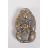 A brass vesta case in the form of a monkey, 7cm high