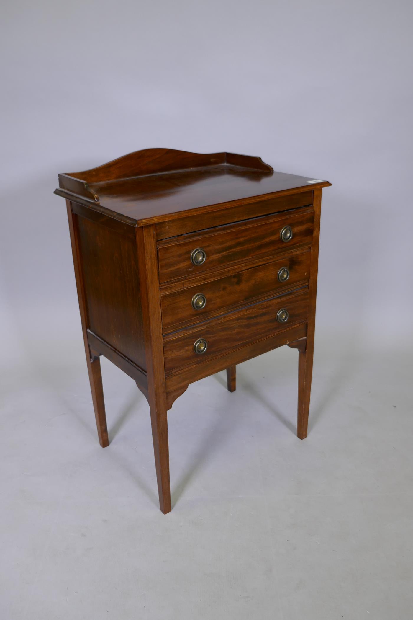 A mahogany three drawer music sheet cabinet with a three quarter gallery and square tapering