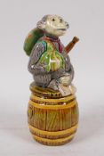 An American majolica jar and cover in the form of an anthropomorphic monkey seated on a barrel, 18cm