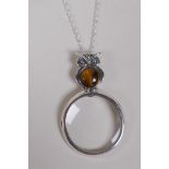 A 925 silver magnifying glass pendant necklace with owl finial and tiger's eye setting, 6cm drop