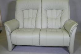 A German Himolla 'Rhine' leather two seat sofa in a pistachio green, 154cm wide