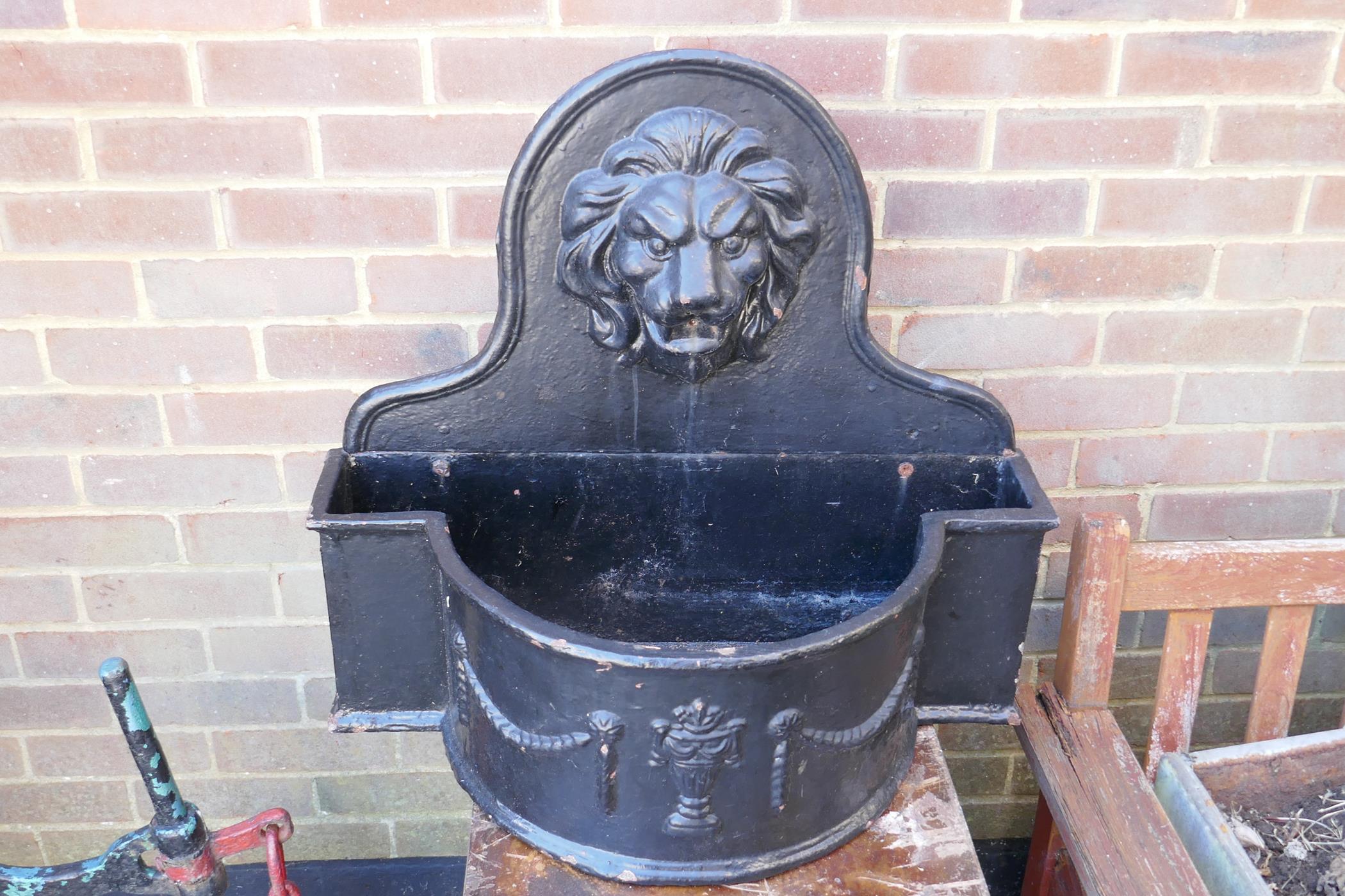 A painted cast iron wall fountain with lion's mask spout, 70 x 84cms, 65cm high - Image 2 of 3