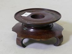 A Chinese carved wood vase stand, 19cm diameter, 8.5cm high