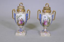 A pair of Augustus Rex porcelain urns and covers with hand painted decoration