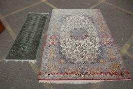 A faded cream ground Persian silk rug, with a floral medallion design and red borders, 160 x 240cms,