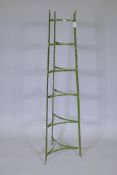 A wrought iron six tier pot stand, 127cm high