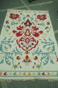 A flat weave woollen rug with asymmetric floral design, 234 x 159cms