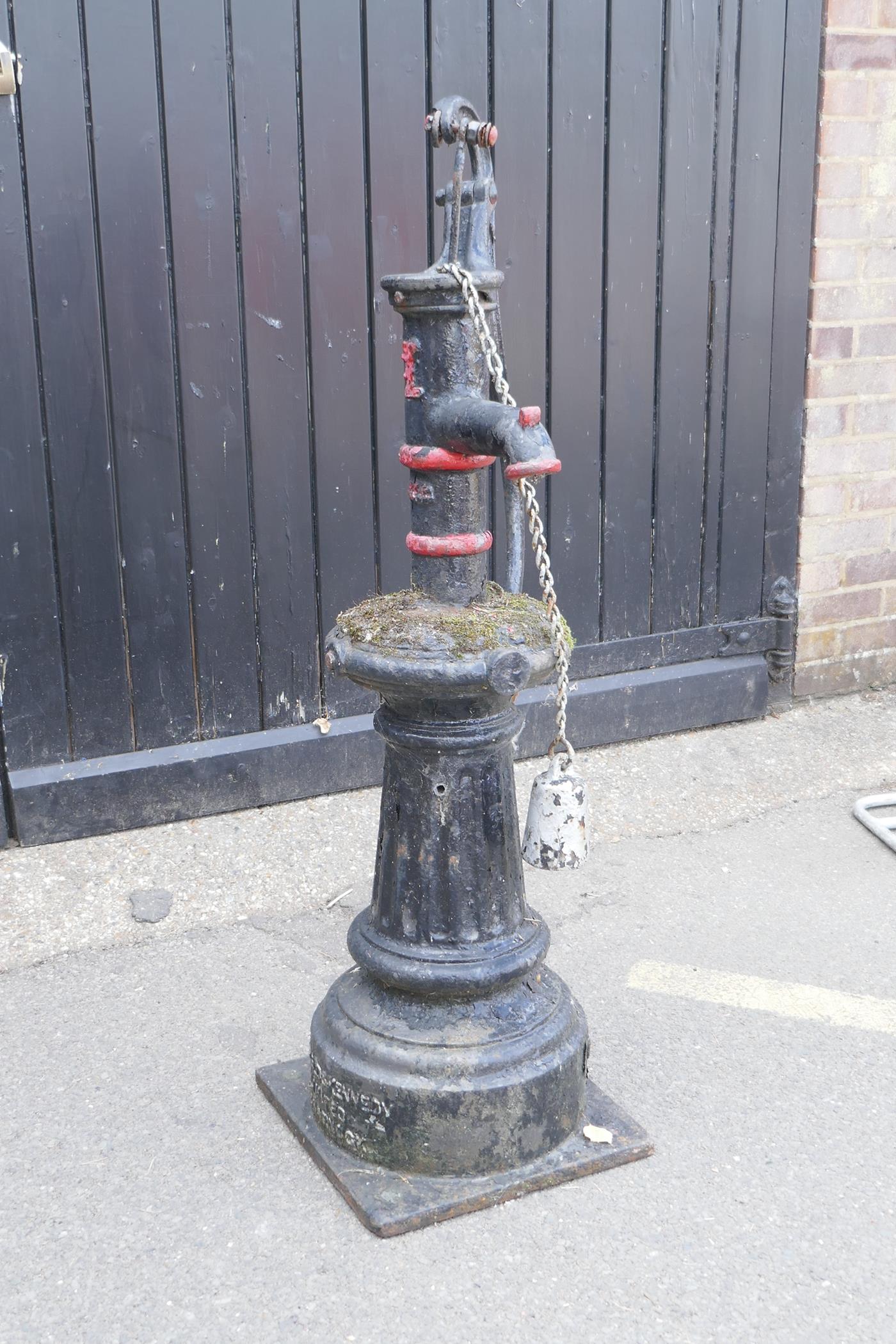 A late Victorian cast iron water pump with attached drinking cup, made by Glenfield & Kennedy,