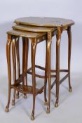 A nest of three 1920s mahogany occasional tables, with raised Chinoiserie decoration and gilt