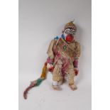 An Indonesian carved and painted wood and fabric Hanuman puppet, 43cm high