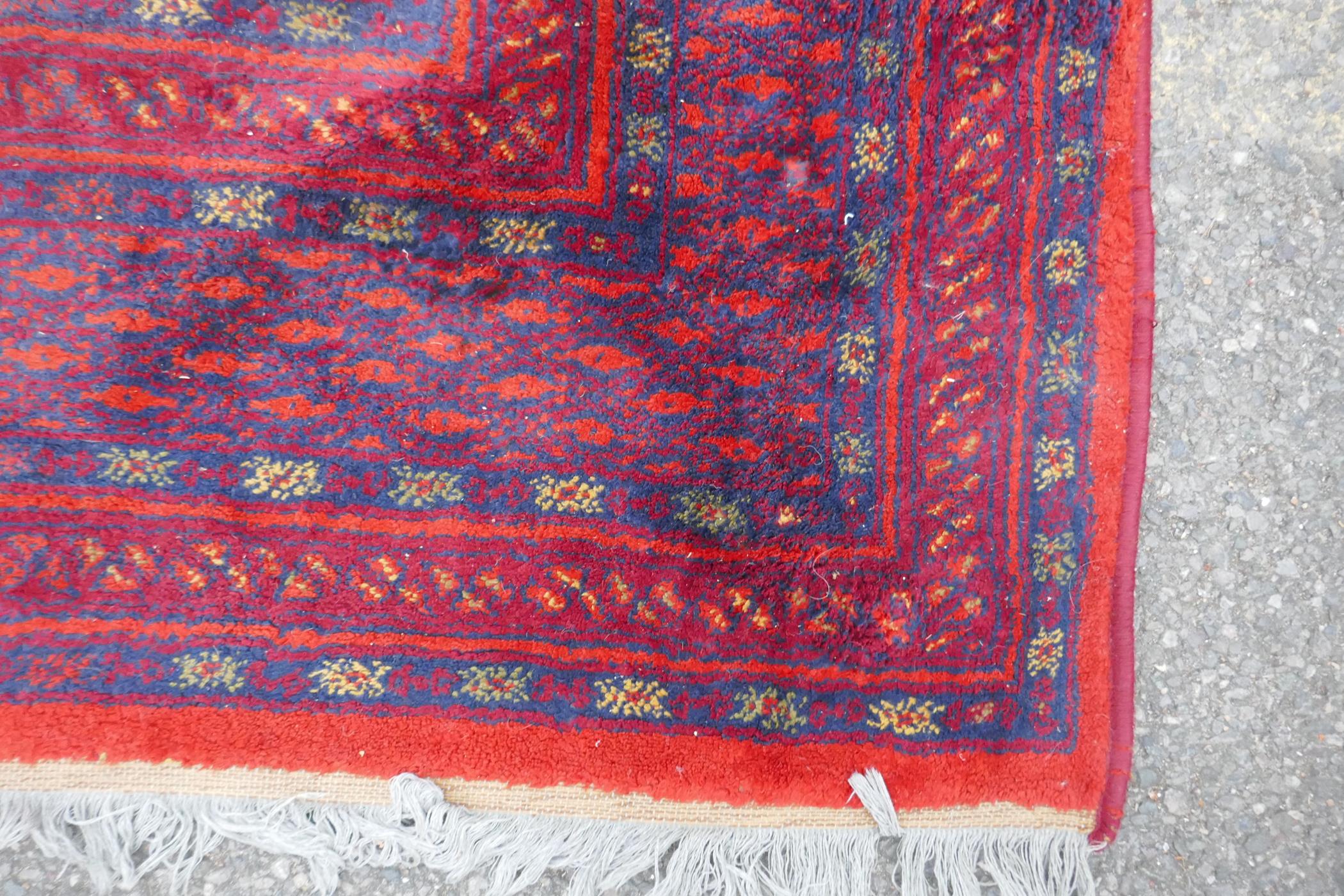 A Turkish Bokhara wool carpet with a tomato red field, 190 x 278cm - Image 4 of 5