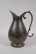 An Indo Persian silvered metal ewer/jug with bidri style tree of life decoration, 22cm high