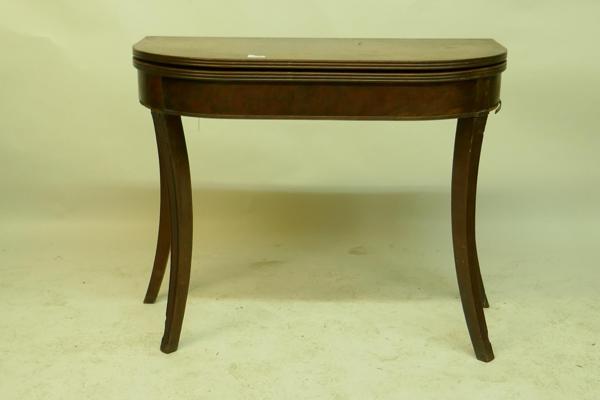 A Georgian mahogany D shaped tea table with reeded edge and cross-banded top, raised on carved sabre - Image 2 of 4