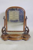 A Victorian mahogany swing toilet mirror with arched frame and three wells, raised on bun feet, 80 x