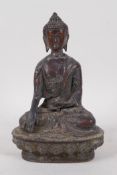 A Sino Tibetan bronze Buddha seated on a lotus throne, 20cm high