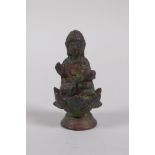 A Tibetan bronze figure of Buddha seated on a lotus flower, 6cm high