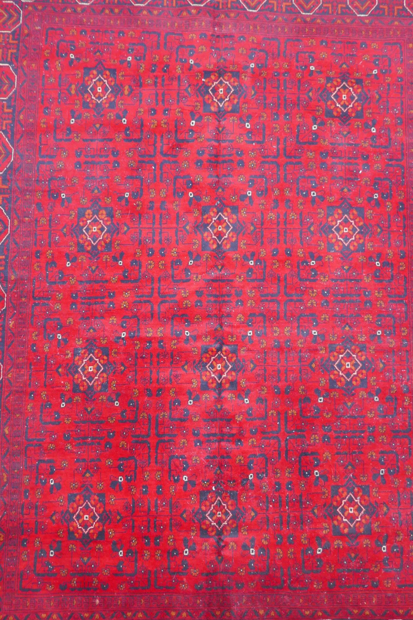 A Turkish deep red ground wool carpet with unique repeating floral geometric design, 165 x 230cms - Image 3 of 5
