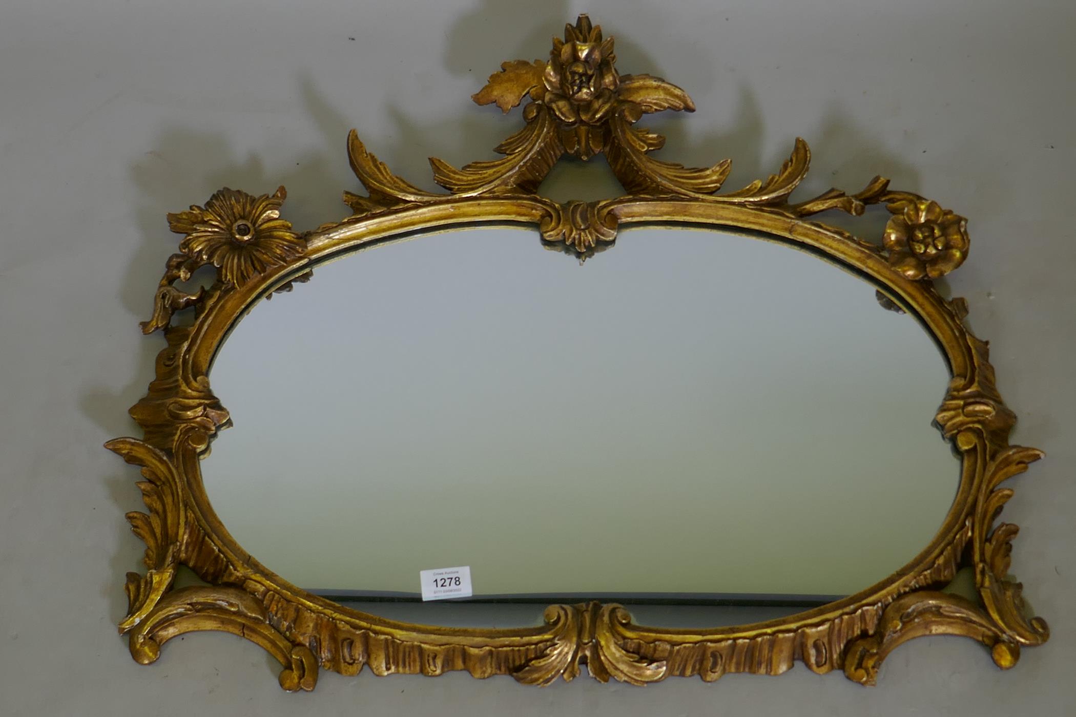 An antique carved giltwood wall mirror, 76 x 63cms