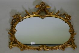 An antique carved giltwood wall mirror, 76 x 63cms