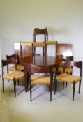 A mid century Danish rosewood extending dining with two extra leaves, and a set of eight dining