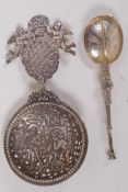 A silver caddy spoon embossed with figures and angels, marked BML 925 and maple leaf, 11cm long,